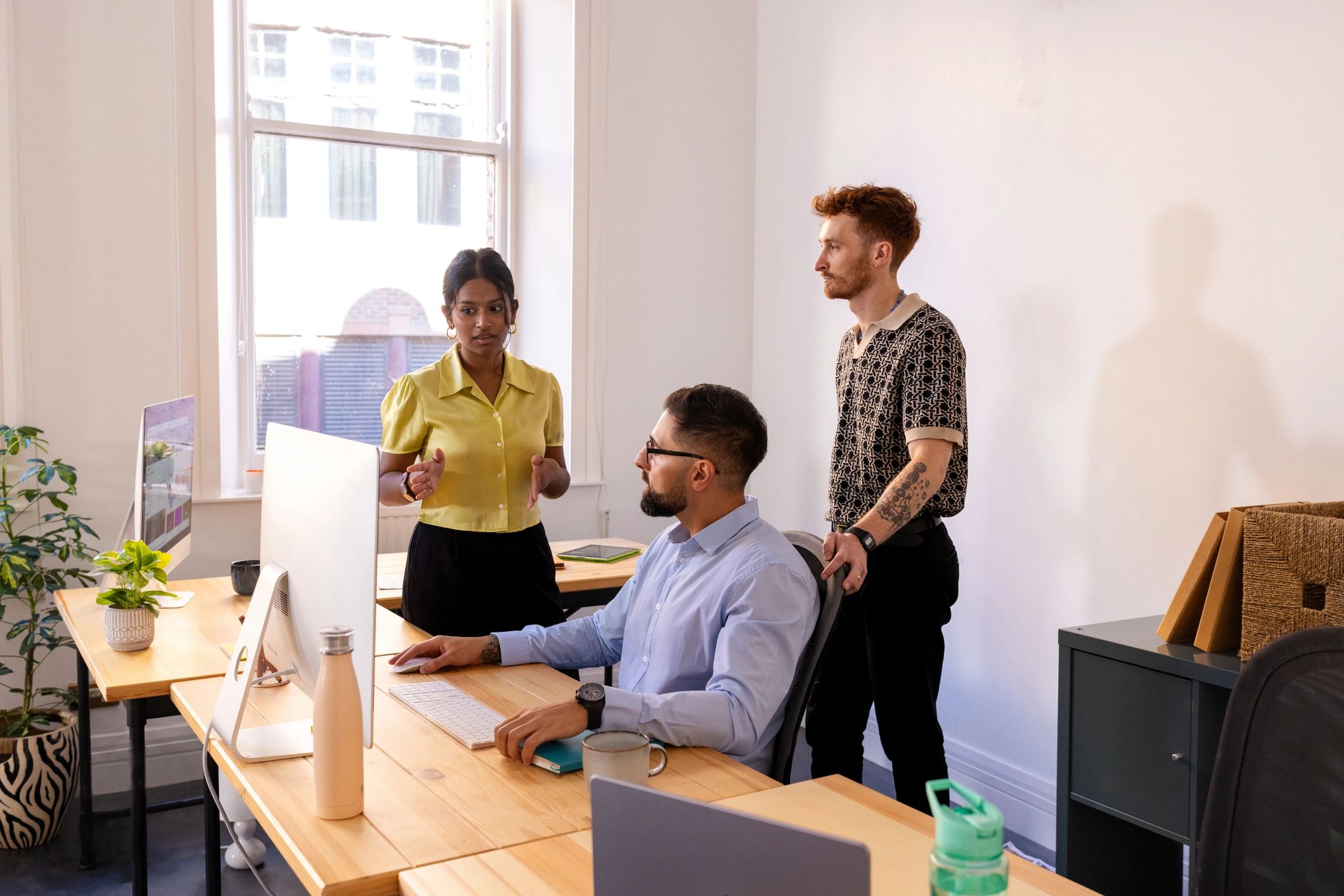 Creative agency team collaborating in a modern workspace